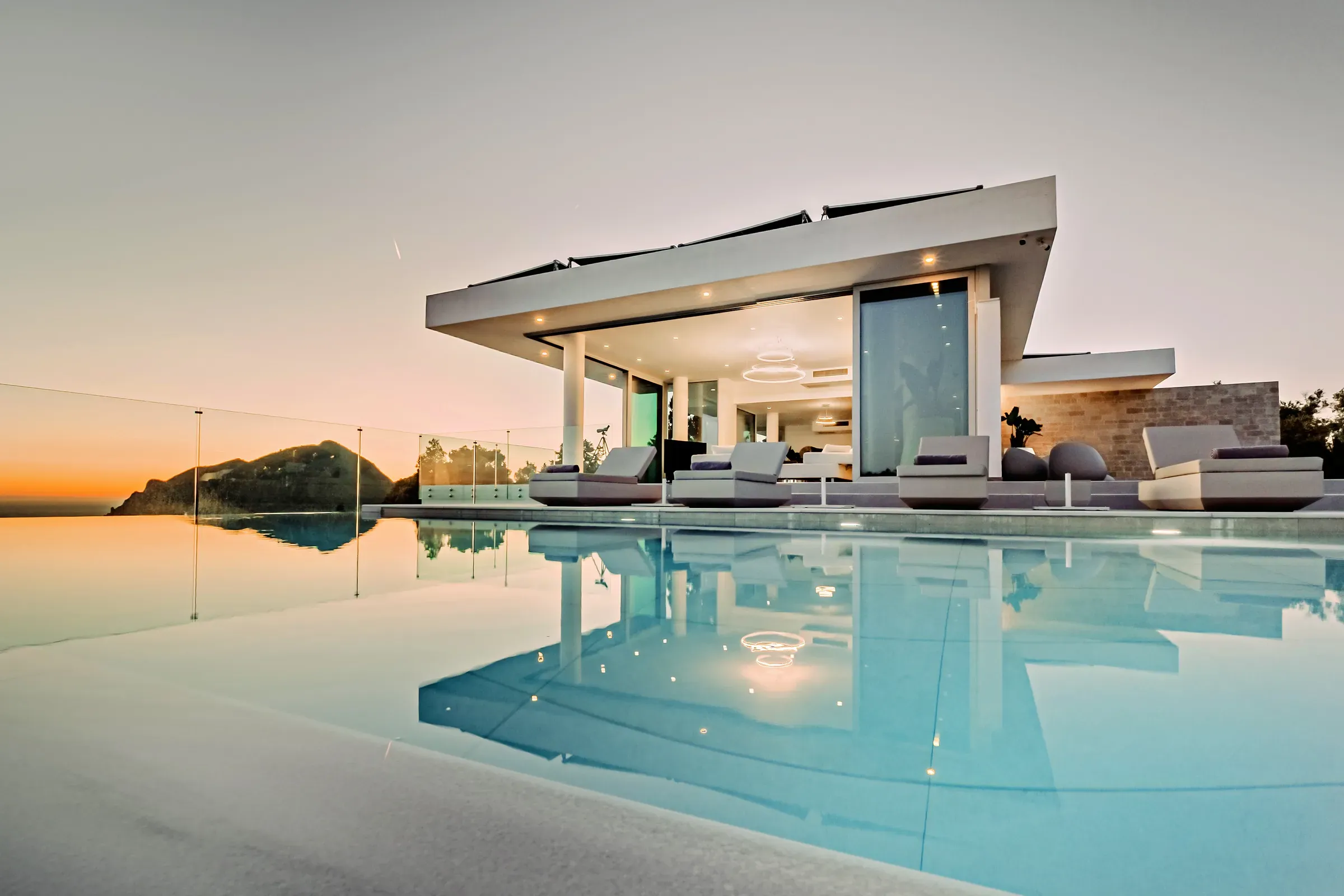 Infinity pool and villa at sunset