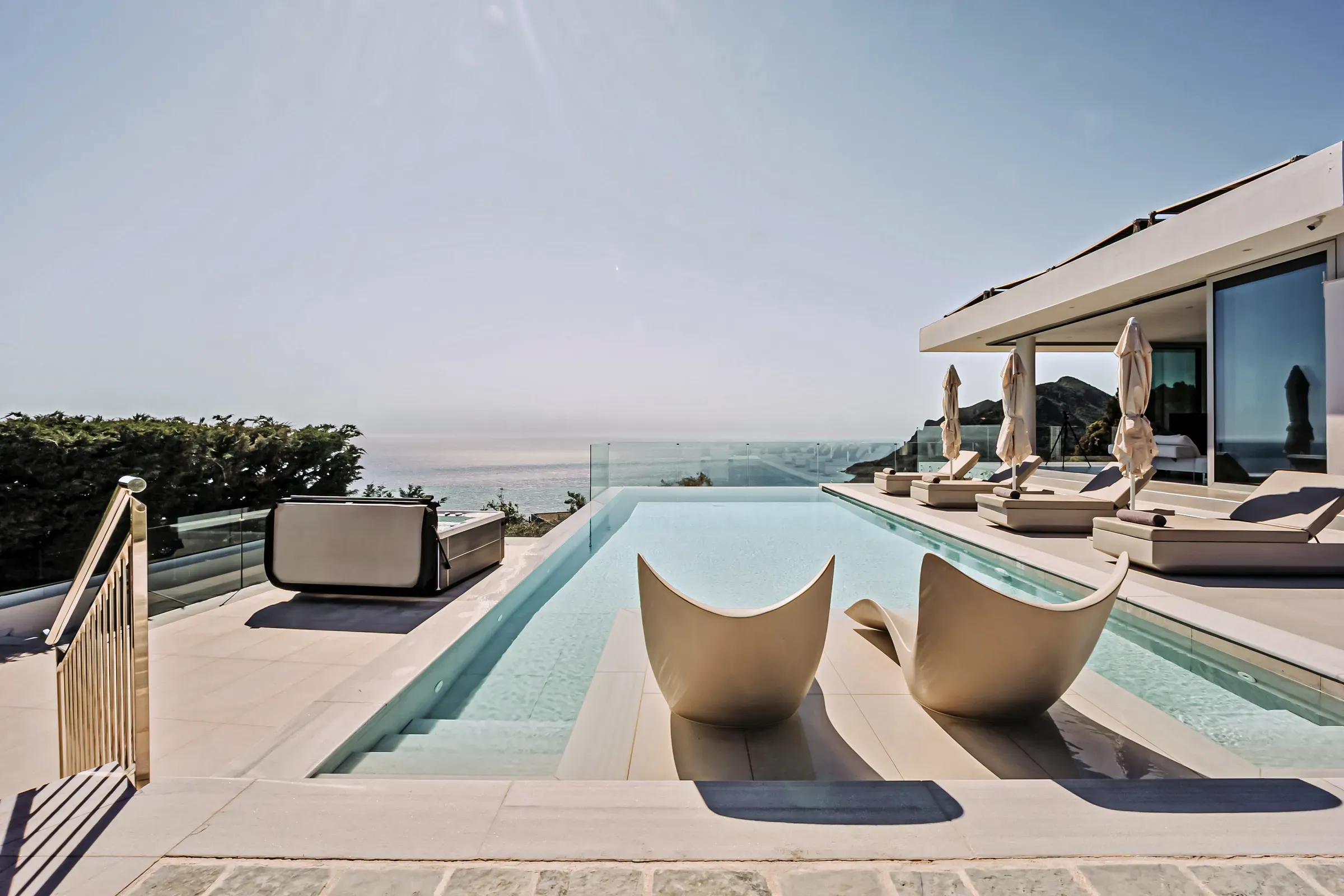 Sculptural sun loungers by the pool