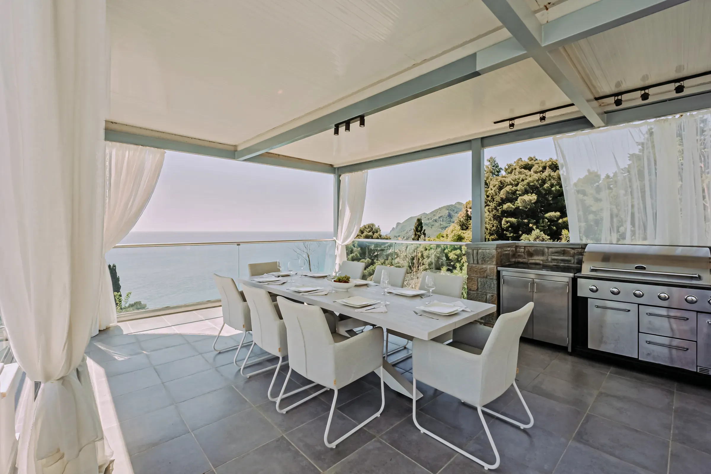 Covered outdoor dining area with sea view
